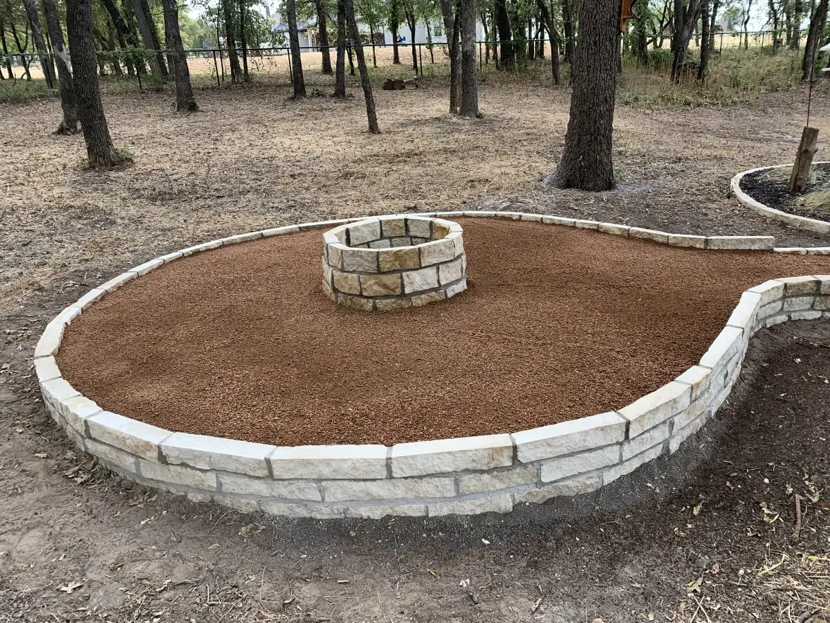 Desert scape xeriscaping with fire pit area and decorative rock in Weatherford TX